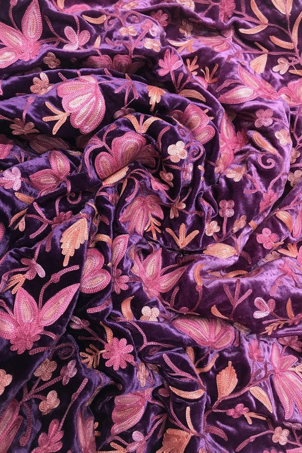 Close-up of purple fabric with pink floral pattern