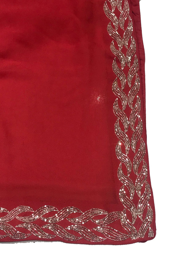 Red fabric with silver embroidery on a white background