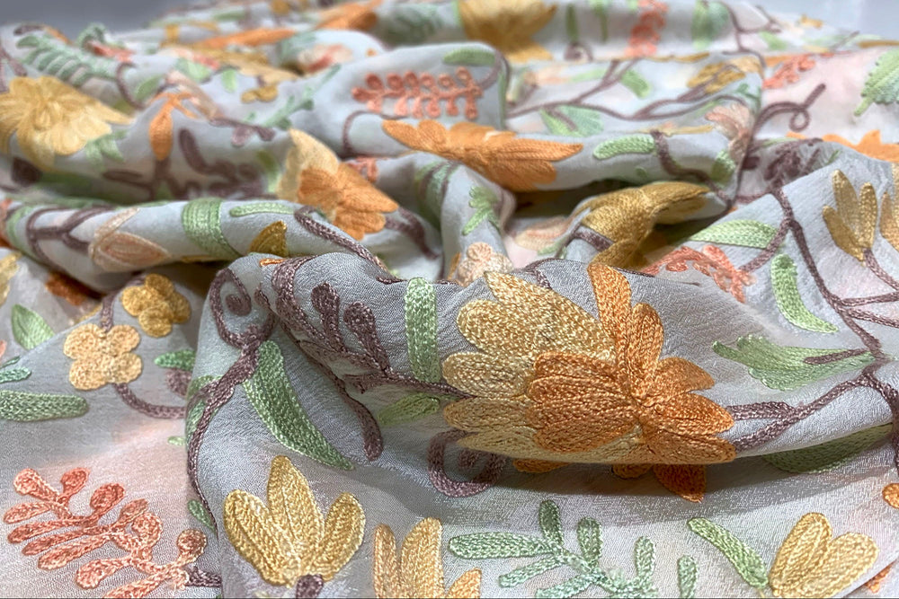 Embroidered fabric with floral patterns on a light background